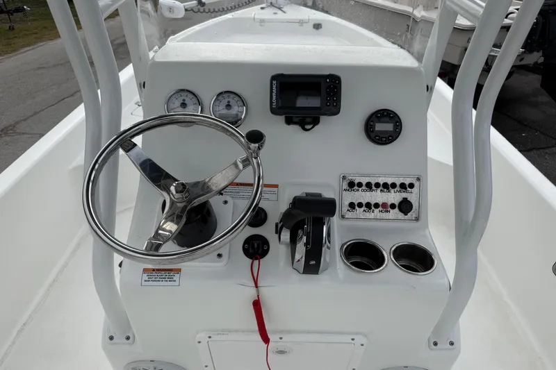 Slide: The Image of 2022 Clearwater 2100 Baystar boat console with steering wheel and controls. - 9