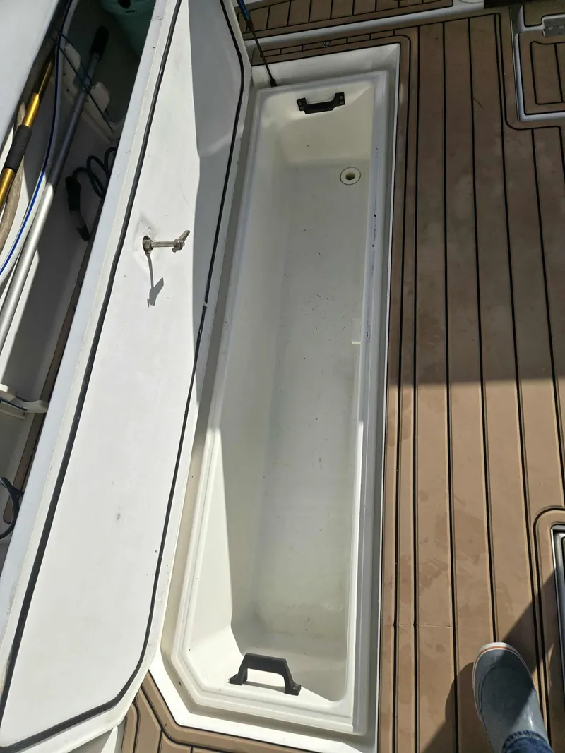 Slide: The Image of Open storage compartment on a 2002 Rampage 38 Express boat. - 13