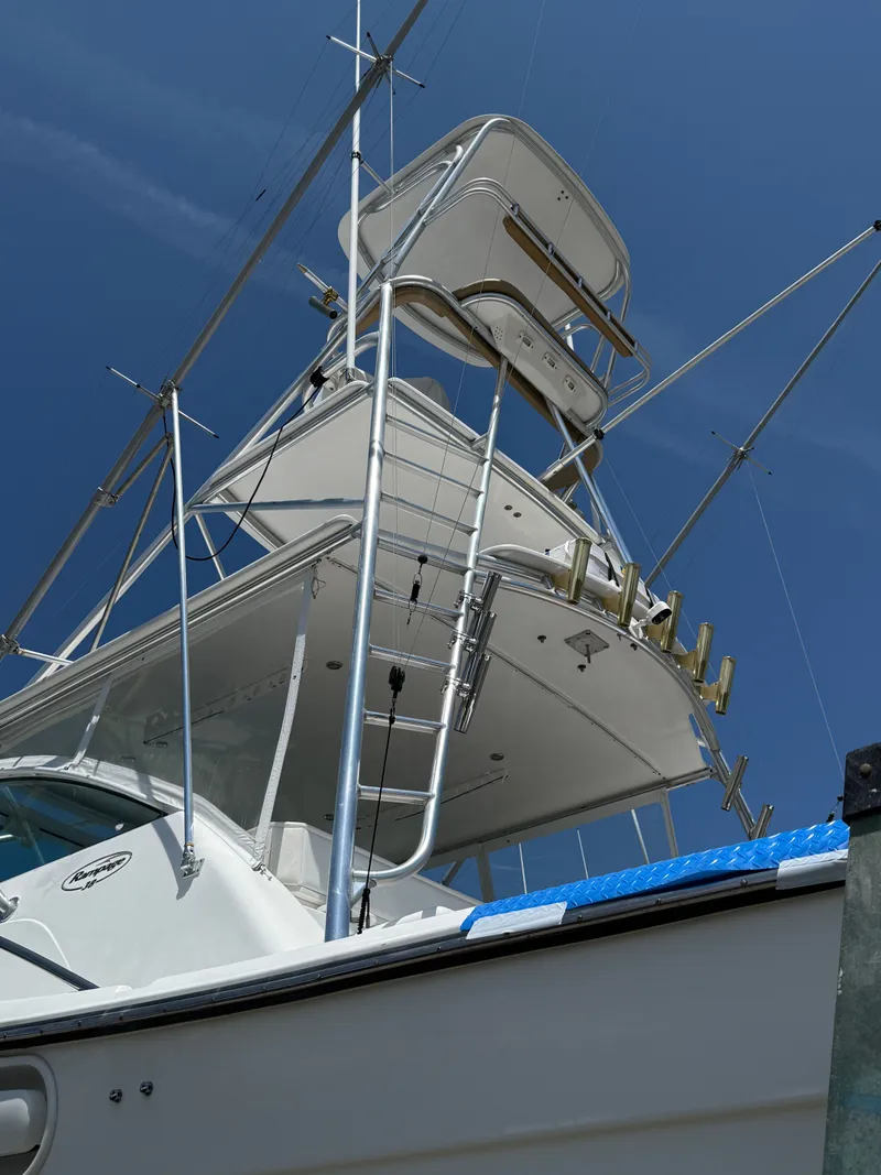 Slide: The Image of 2002 Rampage 38 Express boat with tower against blue sky. - 15