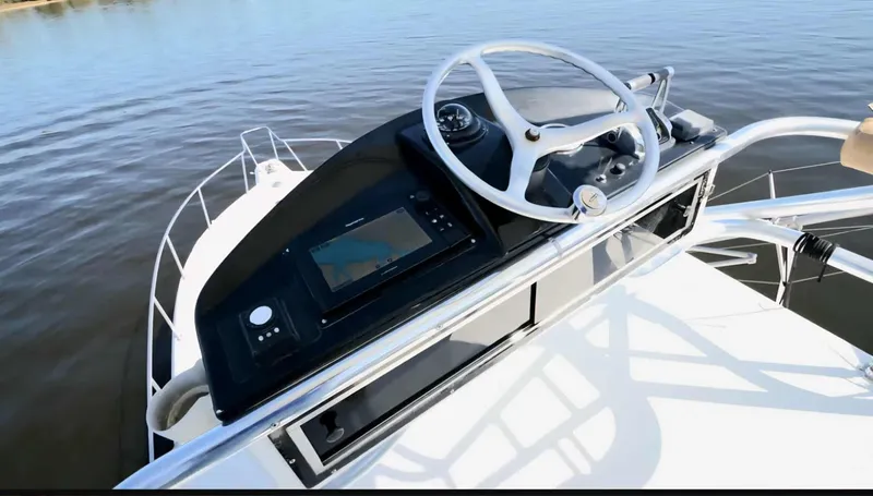 Slide: The Image of Helm of 2002 Rampage 38 Express on calm water. - 18