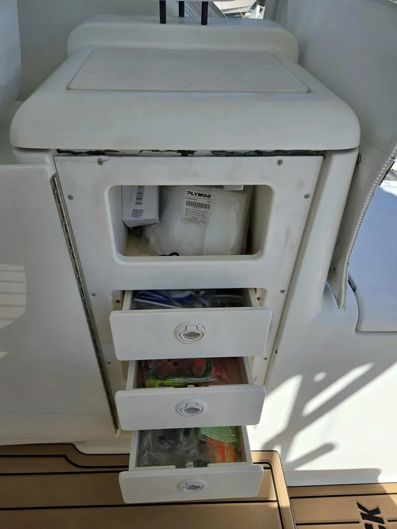Slide: The Image of Storage drawers on a 2002 Rampage 38 Express boat. - 21
