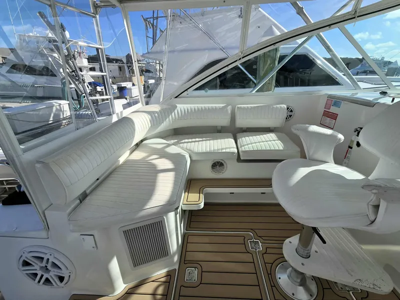 Slide: The Image of Interior of a 2002 Rampage 38 Express yacht with white seating. - 24