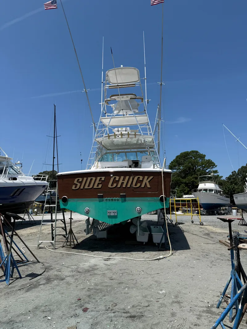 Slide: The Image of 2002 Rampage 38 Express boat in dry dock, "Side Chick". - 3