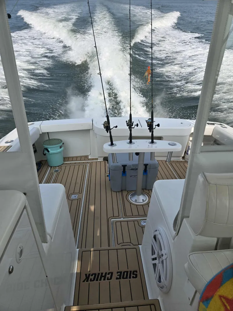 Slide: The Image of Rear view of 2002 Rampage 38 Express yacht on water. - 32