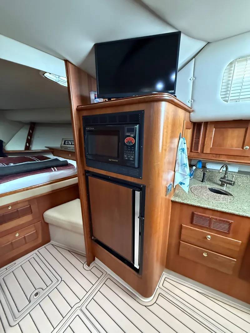 Slide: The Image of Interior of a 2002 Rampage 38 Express yacht with kitchenette. - 38