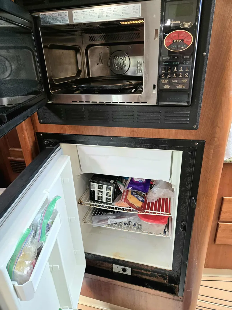 Slide: The Image of Microwave and fridge in 2002 Rampage 38 Express boat. - 39