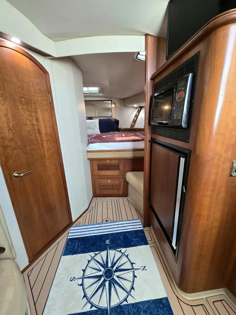 Slide: The Image of Interior of a 2002 Rampage 38 Express yacht with wooden furnishings. - 42