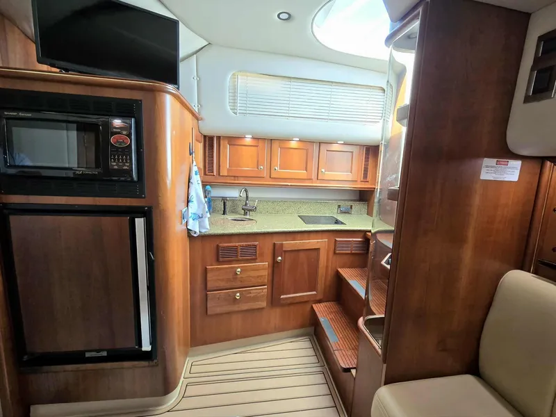 Slide: The Image of Interior of 2002 Rampage 38 Express with kitchen and wood finish. - 43
