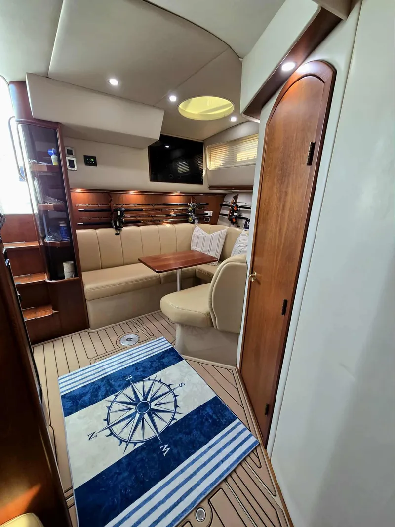 Slide: The Image of Interior of a 2002 Rampage 38 Express yacht with cozy seating area. - 44