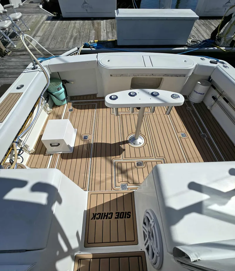 Slide: The Image of Deck of a 2002 Rampage 38 Express boat with wooden flooring. - 7