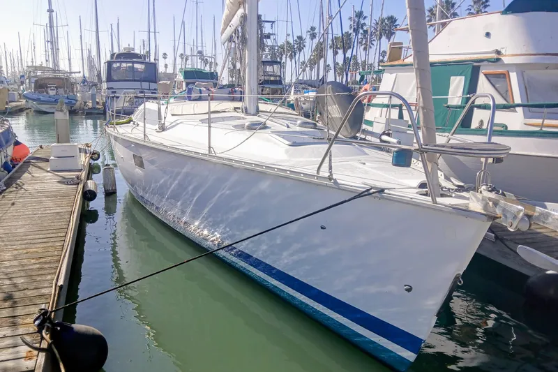 The Image of 1994 Hunter Legend 40 sailboat docked in a marina, surrounded by other boats. - 0