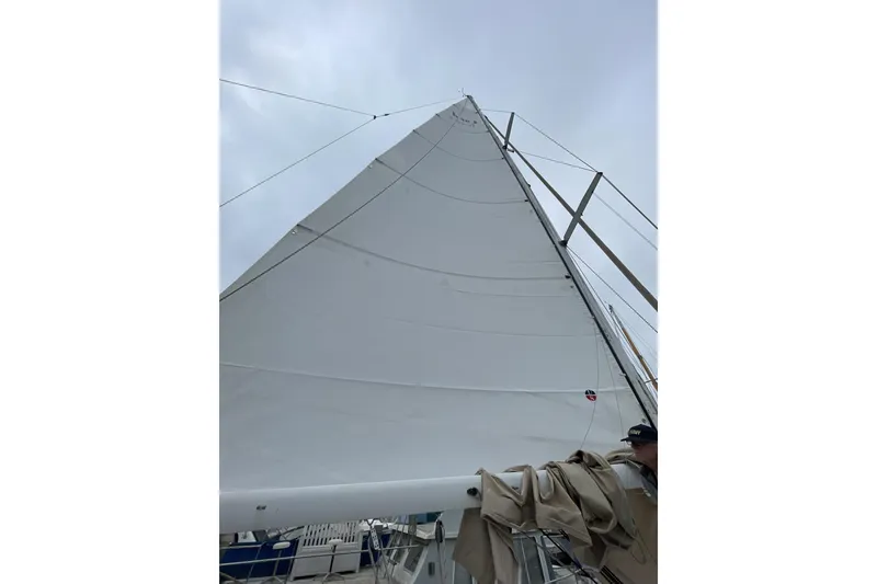 Slide: The Image of Sail of 1994 Hunter Legend 40 yacht against cloudy sky. - 11