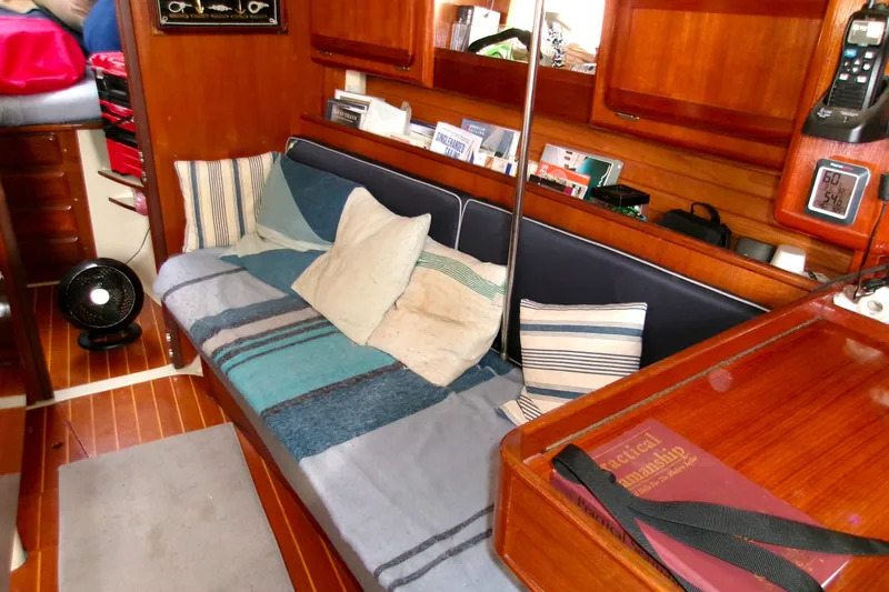 Slide: The Image of Cozy interior of 1994 Hunter Legend 40 sailboat with cushions and wooden cabinetry. - 12