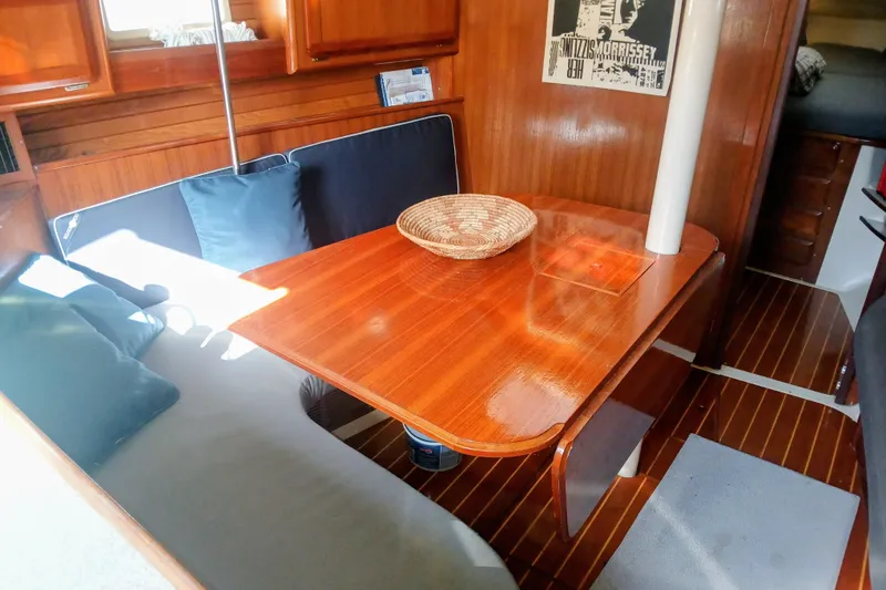 Slide: The Image of Interior of 1994 Hunter Legend 40 sailboat with wooden dining table and seating area. - 14
