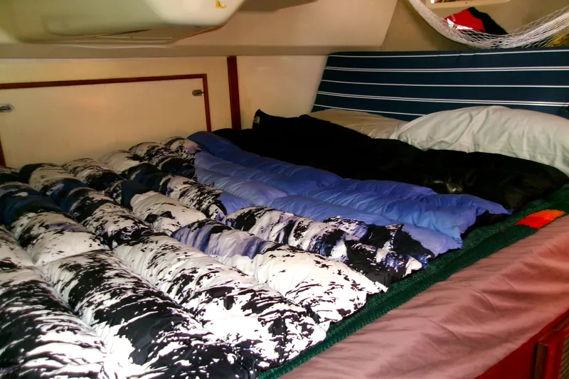 Slide: The Image of Cozy cabin interior of 1994 Hunter Legend 40 sailboat with colorful bedding. - 16