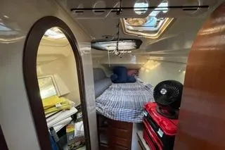 Slide: The Image of Cozy cabin interior of 1994 Hunter Legend 40 sailboat with bed and storage. - 18