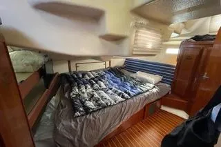 Slide: The Image of 1994 Hunter Legend 40 yacht interior with cozy bed and wooden cabinetry. - 19
