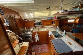 Slide: The Image of 1994 Hunter Legend 40 yacht interior with wooden cabinetry and kitchen amenities. - 22