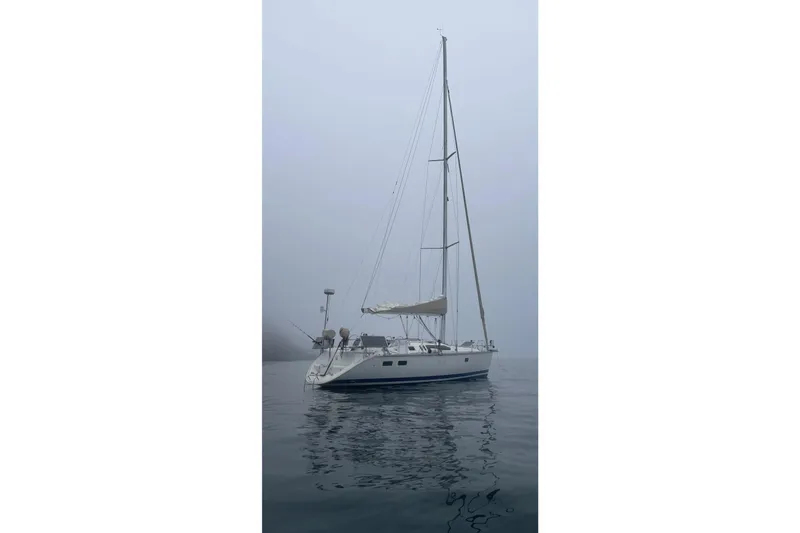 Slide: The Image of Sailboat Hunter Legend 40, 1994 model, anchored in foggy waters. - 27
