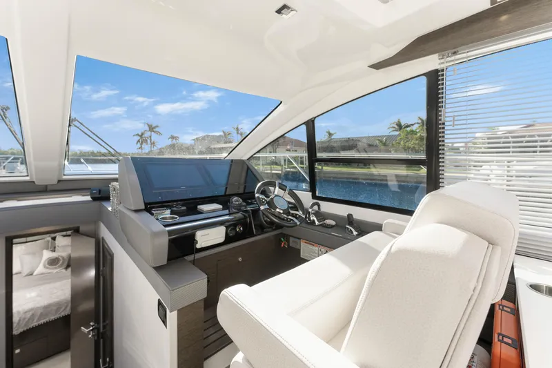 Slide: The Image of Luxurious 2018 Cruisers Yachts 50 Cantius helm with modern controls and panoramic windows. - 37