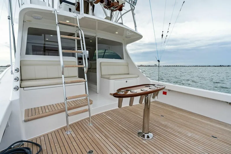 Slide: The Image of 2021 Viking 46 Billfish yacht deck with seating, ladder, and ocean view. - 18