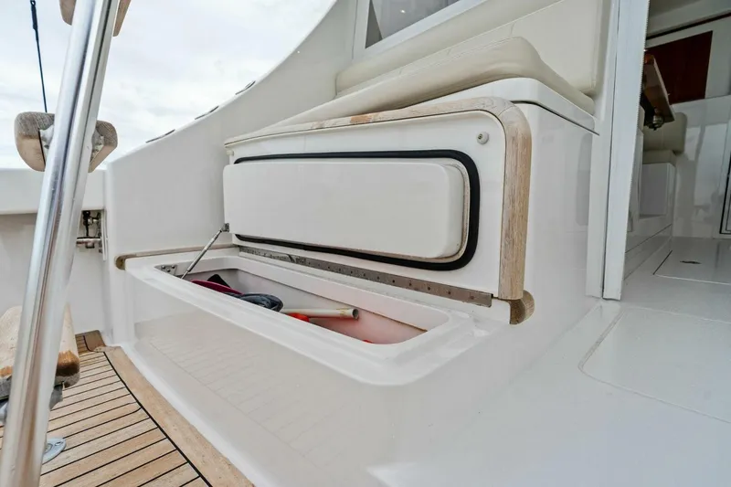 Slide: The Image of Storage compartment on 2021 Viking 46 Billfish yacht, featuring sleek design and wooden accents. - 21
