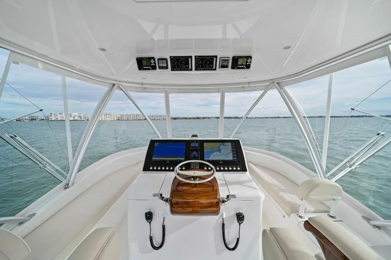 Slide: The Image of 2021 Viking 46 Billfish helm with modern navigation system and panoramic ocean view. - 24