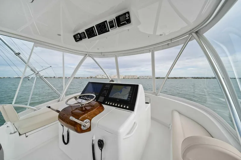 Slide: The Image of Helm of 2021 Viking 46 Billfish yacht with navigation controls and ocean view. - 31