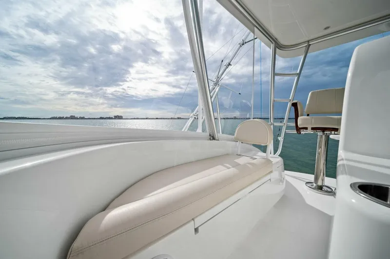Slide: The Image of 2021 Viking 46 Billfish yacht interior with seating, ocean view, and clear sky. - 40
