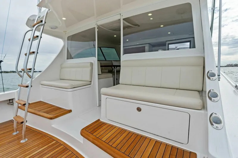 Slide: The Image of 2021 Viking 46 Billfish yacht interior with teak flooring and cushioned seating. - 46