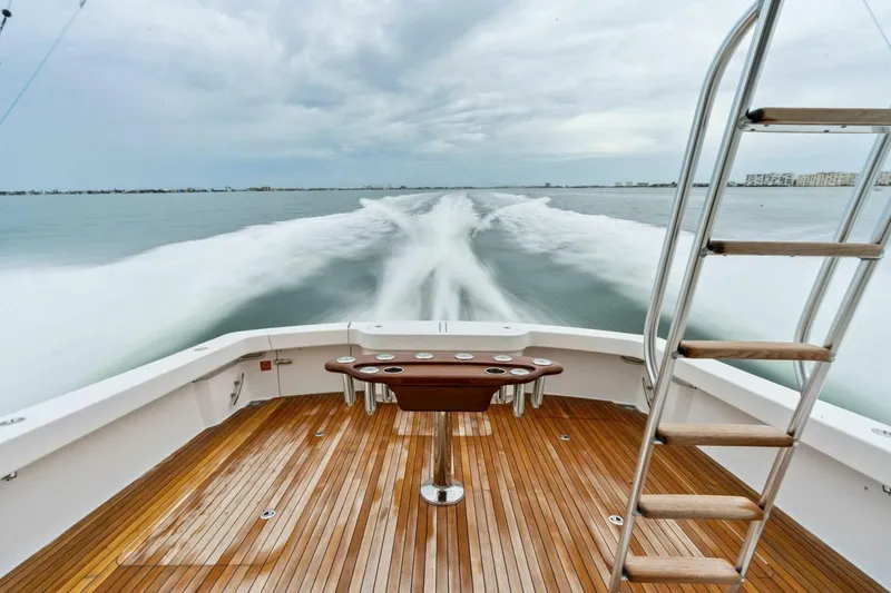 Slide: The Image of 2021 Viking 46 Billfish yacht cruising, showcasing sleek wooden deck and ocean view. - 47