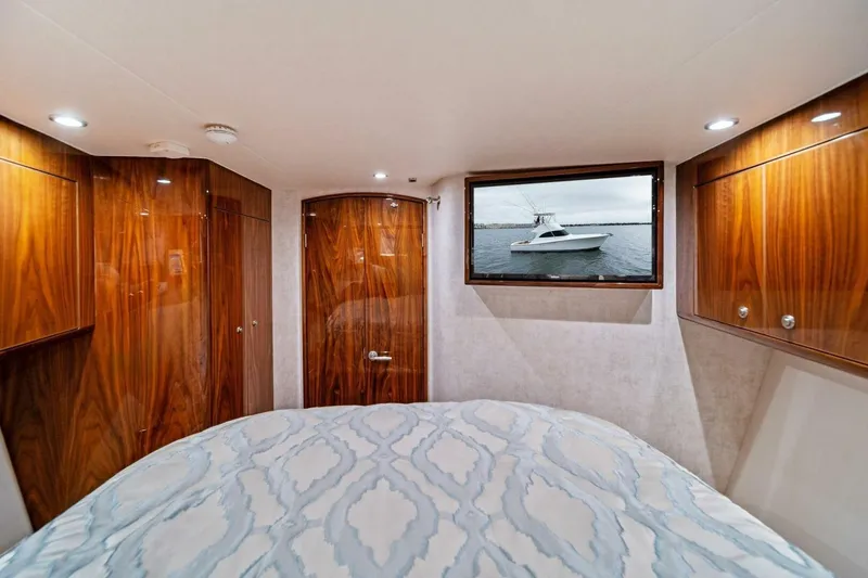 Slide: The Image of Luxurious cabin interior of 2021 Viking 46 Billfish yacht with wood paneling and bed. - 52