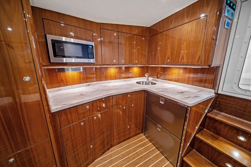Slide: The Image of Luxurious galley in 2021 Viking 46 Billfish yacht with wood cabinetry and modern appliances. - 56