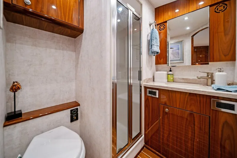 Slide: The Image of Luxurious bathroom in 2021 Viking 46 Billfish yacht with wood cabinetry and modern fixtures. - 63