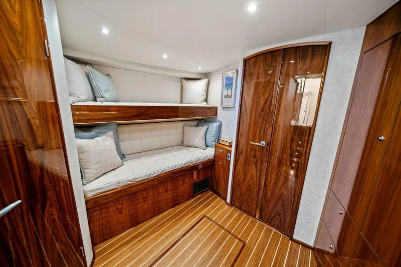 Slide: The Image of Luxurious cabin interior of 2021 Viking 46 Billfish yacht with wooden finishes and cozy bunks. - 66