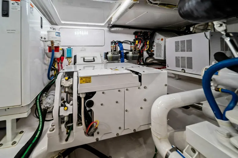 Slide: The Image of Engine room of 2021 Viking 46 Billfish yacht, showcasing mechanical systems and wiring. - 74