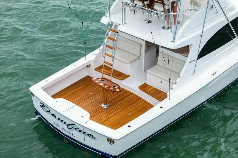 Slide: The Image of 2021 Viking 46 Billfish yacht with teak deck, ladder, and seating, cruising on the ocean. - 76