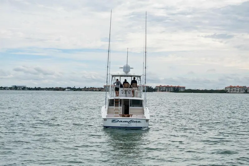 Slide: The Image of 2021 Viking 46 Billfish yacht cruising on calm waters under a cloudy sky. - 78