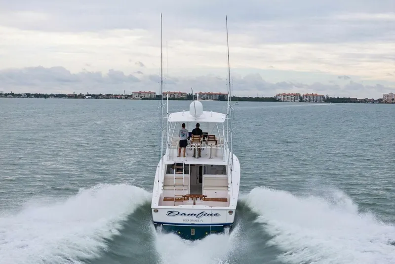 Slide: The Image of 2021 Viking 46 Billfish yacht cruising on open water, rear view. - 94