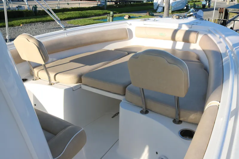 Slide: The Image of 2016 Sea Hunt Gamefish 25 boat interior with beige cushioned seating. - 7