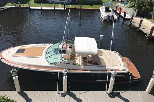 The Image of 2006 Chris Craft Corsair Heritage boat docked in a marina, aerial view. - 0