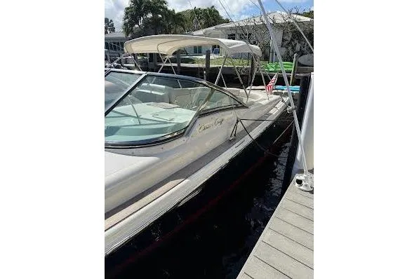 Slide: The Image of 2006 Chris Craft Corsair Heritage boat docked at marina under sunny skies. - 11