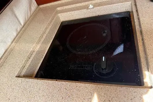 Slide: The Image of 2006 Chris Craft Corsair Heritage interior with white seating and wooden table. - 19