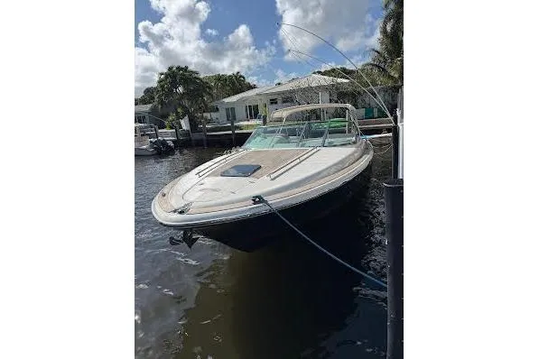 Slide: The Image of 2006 Chris Craft Corsair Heritage boat docked on a sunny day, showcasing sleek design. - 2