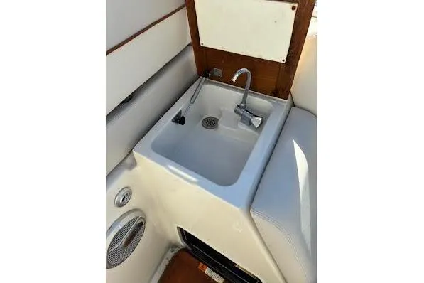 Slide: The Image of 2006 Chris Craft Corsair Heritage boat interior with sink and storage cabinets. - 29