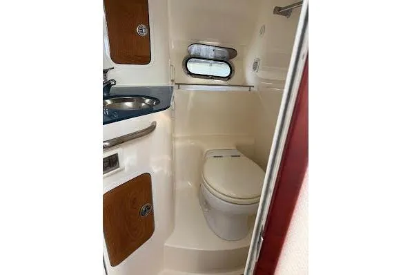 Slide: The Image of 2006 Chris Craft Corsair Heritage interior with wooden steps and compact kitchenette. - 32