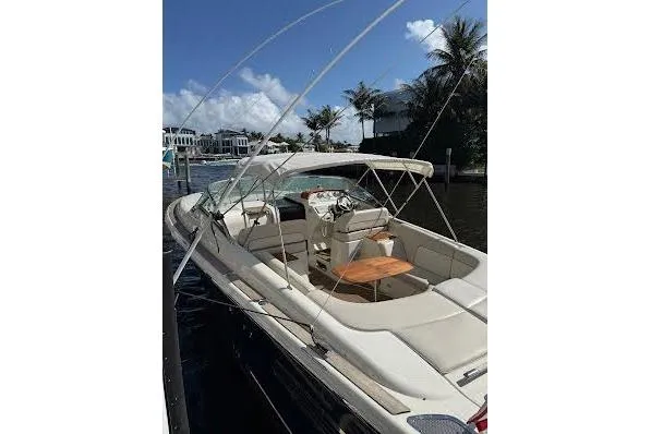 Slide: The Image of 2006 Chris Craft Corsair Heritage boat docked, featuring elegant seating and a wooden table. - 5