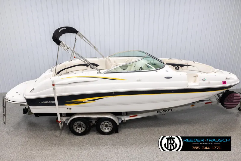 The Image of 2002 Chaparral 243 Sunesta boat on trailer in showroom, side view. - 1