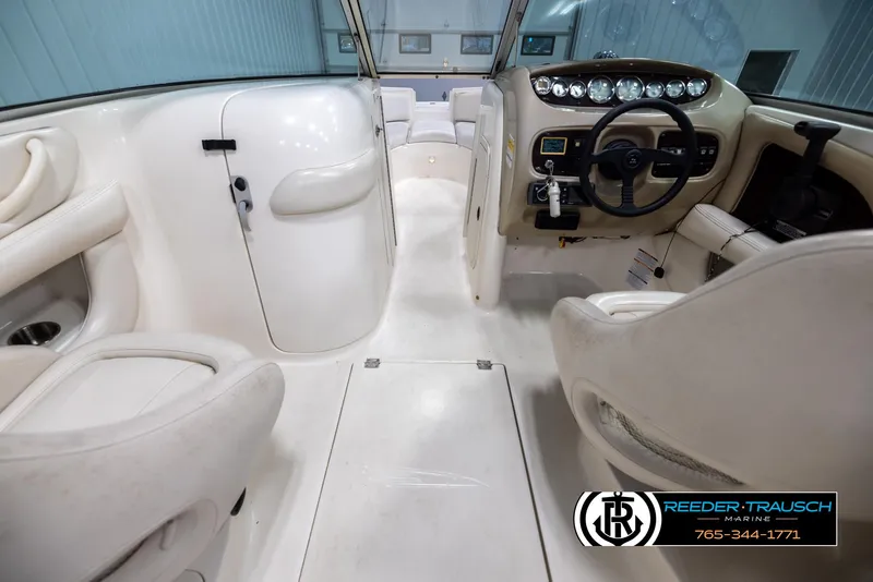 Slide: The Image of Interior of 2002 Chaparral 243 Sunesta boat with steering wheel and seating. - 14