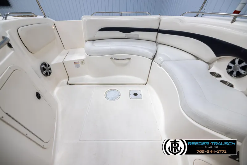 Slide: The Image of Interior of 2002 Chaparral 243 Sunesta boat with white seating and speakers. - 18